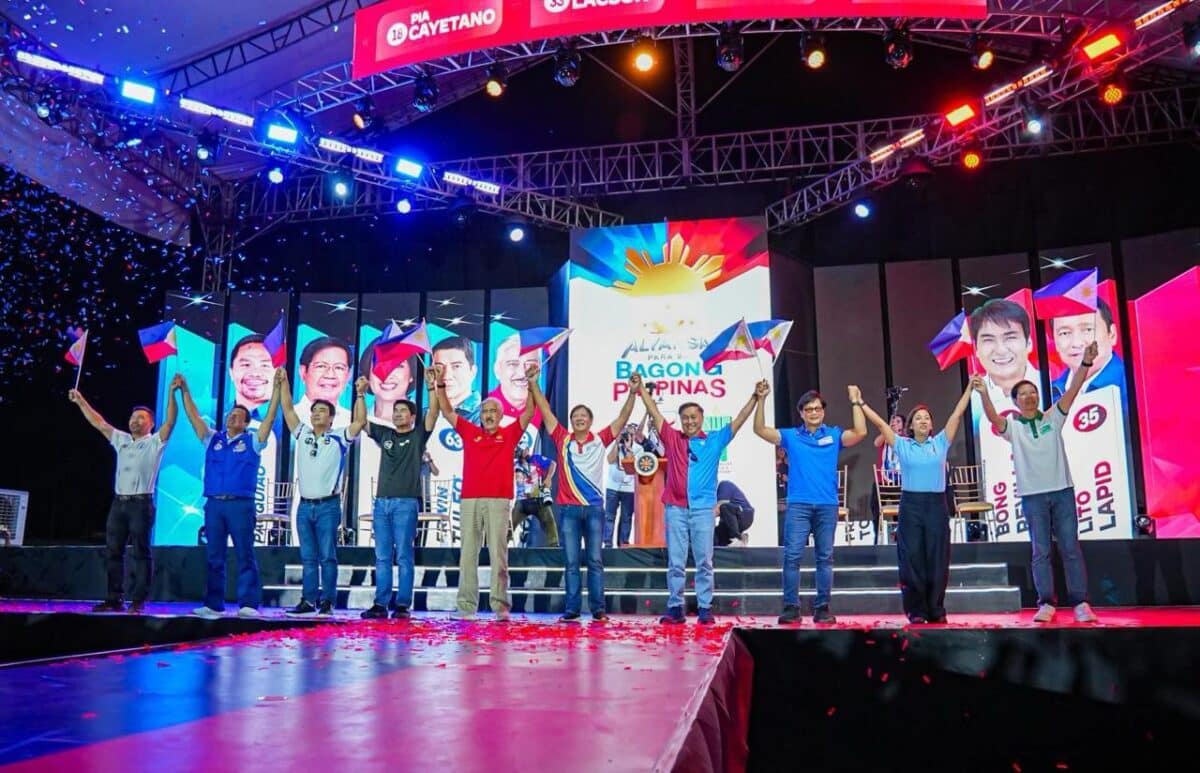 President Marcos raising the hands of Alyansa senatorial candidates in Tacloban rally4. Tacloban residents applaud Abalos' presence in Alyanda rally.